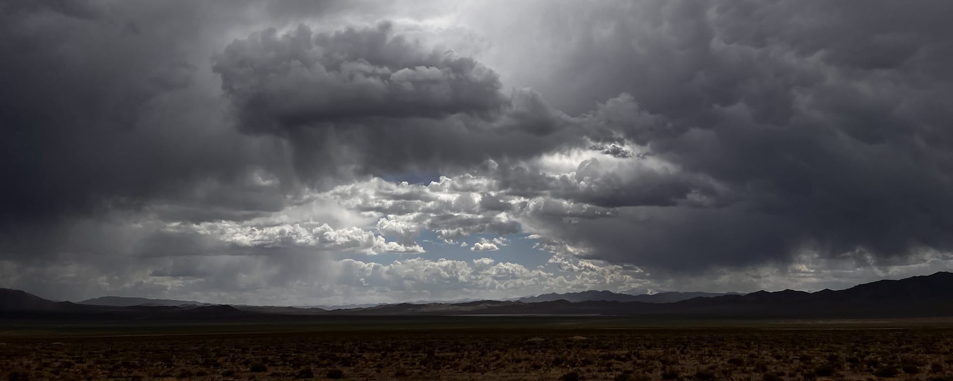 A desert sky with thunderstorms in the distance